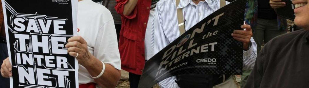 Woman holding Save Our Internet sign